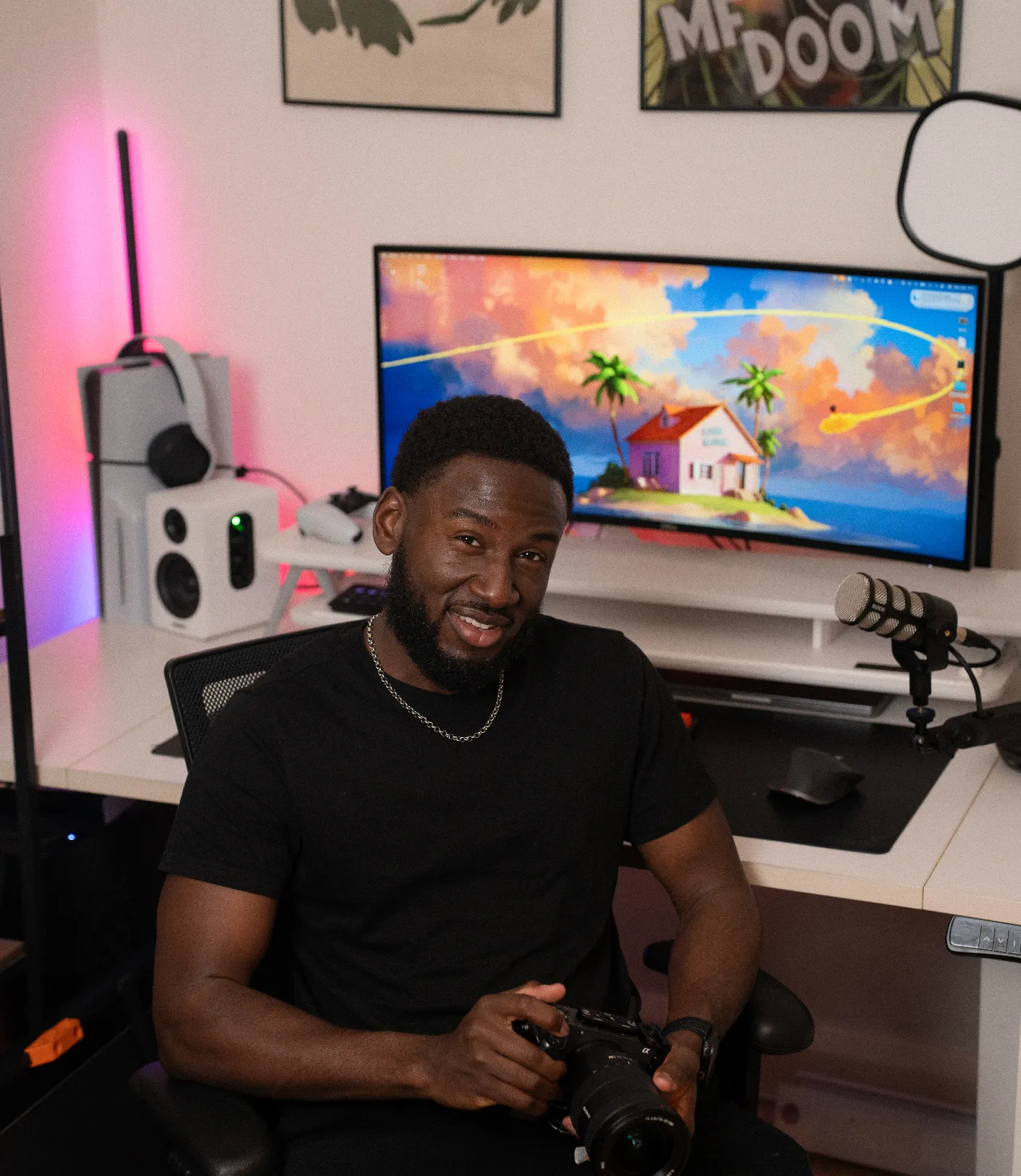 Lawrence at his desk holding a camera